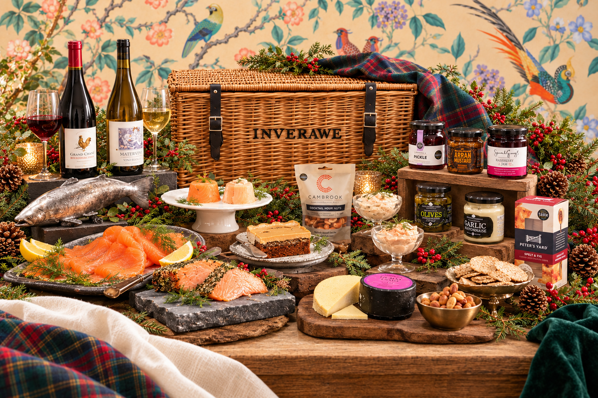 Loch Etive Christmas hamper with Inverawe stencilled onto a wicker basket, displayed against a light bird-patterned backdrop with Christmas greenery.
