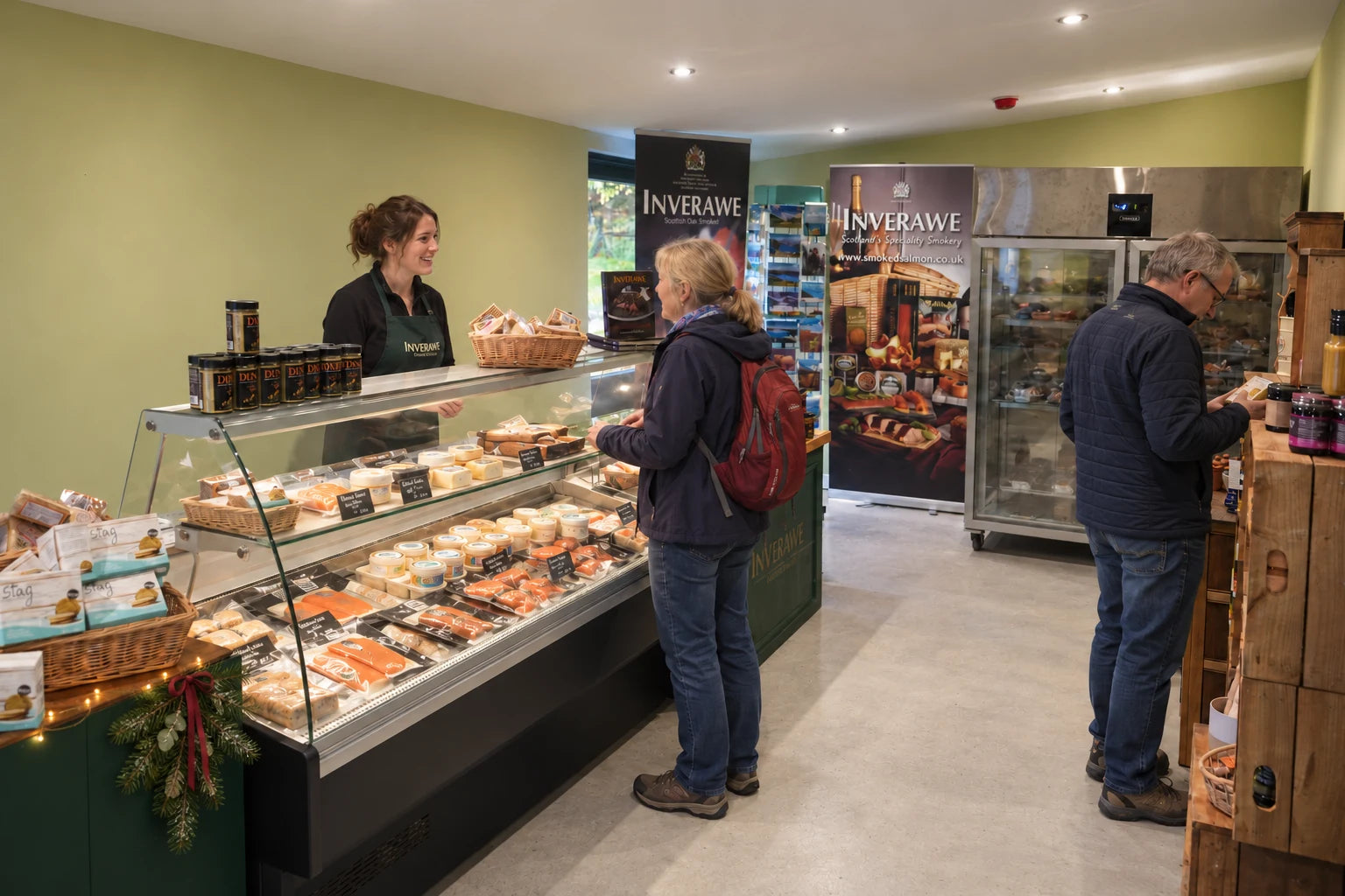 A welcoming Inverawe food counter with smoked salmon, a friendly team and subtle Christmas greenery.